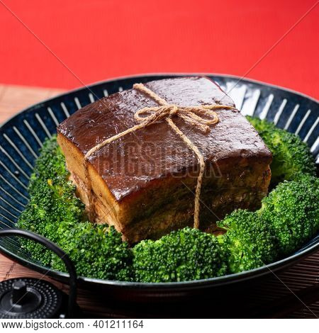 Dong Po Pork Meat In A Blue Plate With Broccoli With Red Background.