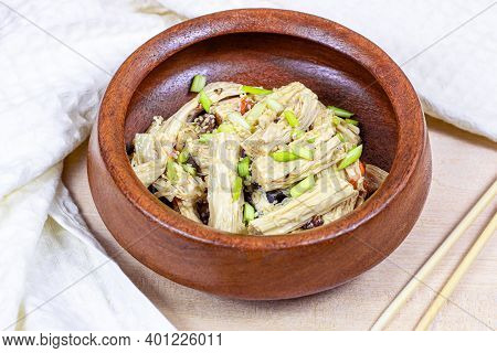 Asian Fuzhu Salad (yuba Sticks, Soy Bean Curd, Tofu Skin) In Round Wooden Bowl On Light Background.
