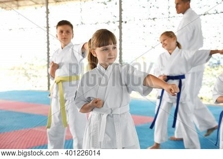 Children In Kimono Practicing Karate On Tatami Outdoors