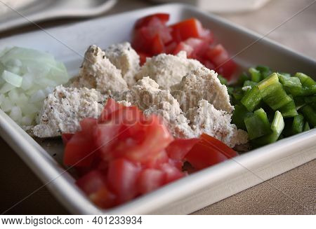 A Plate Of Shanklish With Chopped Tomatoes, Pepper, And Onion.