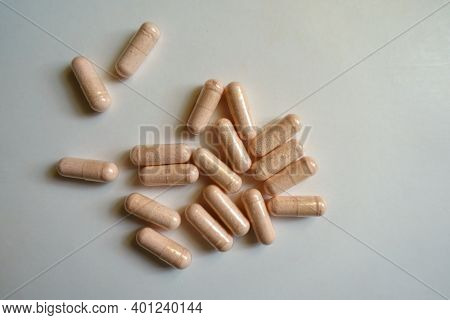 Multiple Pink Capsules Of Probiotic Dietary Supplement From Above