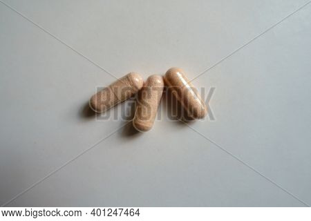 View Of Three Pink Capsules Of Probiotic Dietary Supplement From Above