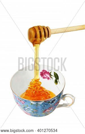 Honey Dripping Ln The Blue Porceline Teacup, Isolated On A White Background