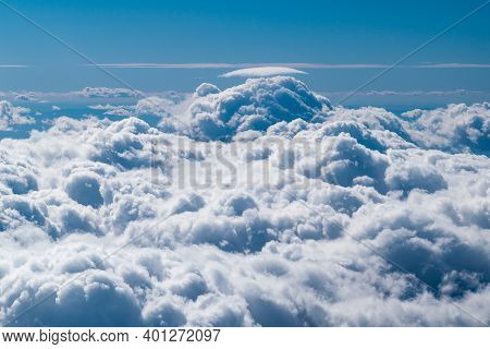 Blue Sky Full Of White Clouds In A Photo Taken In An Airplane