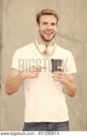 Try This. Happy Man Pointing At Hot Cup Outdoors. Pointing Gesture To Takeaway Drink. Index Finger P