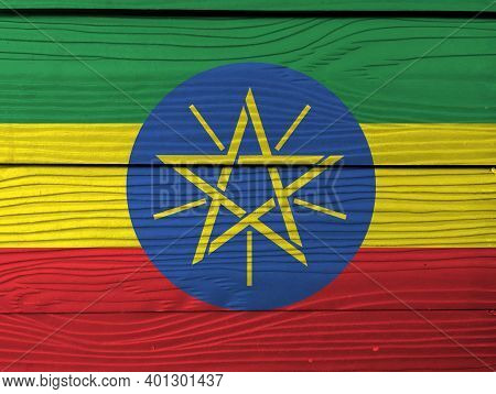 Flag Of Ethiopia On Wooden Wall Background. Grunge Ethiopian Flag Texture, Tricolor Of Green Yellow 