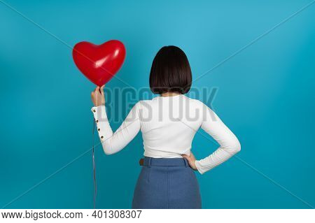 Mock-up Brunette Woman Stands With Her Back And Holds A Red Heart-shaped Balloon, Depersonalized, Is