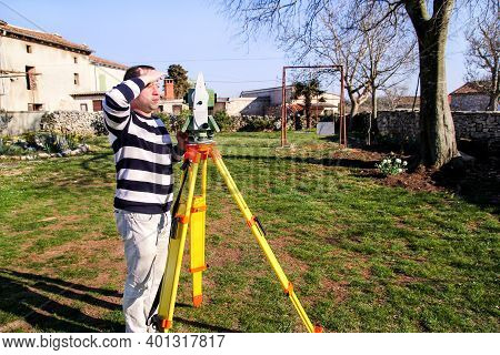 Man Using Of Total Station. Guy Surveyor At Work. Survey Instrument Geodetic Device, Total Station S