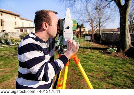Man Using Of Total Station. Guy Surveyor At Work. Survey Instrument Geodetic Device, Total Station S