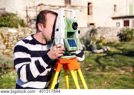 Man Using Of Total Station. Guy Surveyor At Work. Survey Instrument Geodetic Device, Total Station S