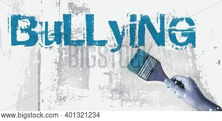 Bullying, Written With Red Paintbrush On A Wall. Conceptual Image.
