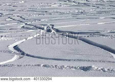 Trace Of Ski And Snowboards In New-fallen Snow, Off-piste Slope. Natural Background.