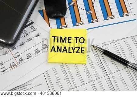 The Time For Analysis Is Written On A Yellow Sheet That Lies On The Documents With A Color Chart And