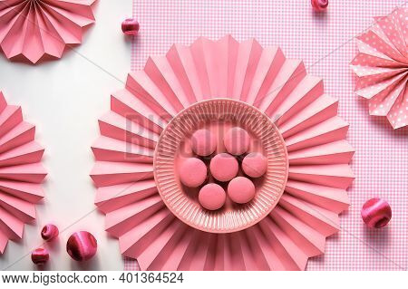Sweet And Tasty Macaroons On A Plate. Creative Food Concept. Monochrome Flat Lay On Checkered Pink C