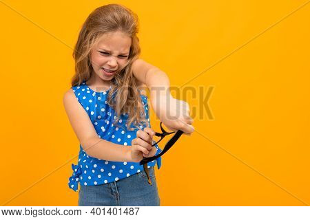 Portrait Of Young Caucaian Girl With Long Fair Hair Hates Her Glasses