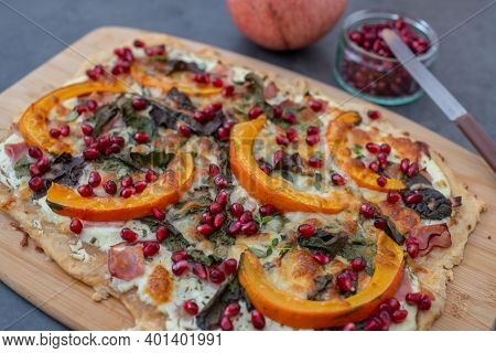 Tarte Flambee With Pumpkin, Cheese, Kale And Pomegranate