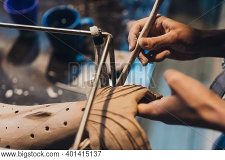 Close-up View Of Female Hands Gently Handling A Clay Whale In Workshop.