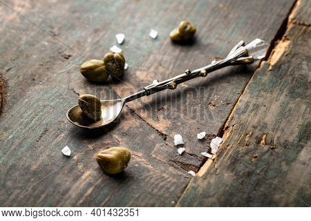 Pickled Capers On A Dark Wooden Background. Edible Flower Buds Of Capparis Spinosa, Caper Bush Or Fl
