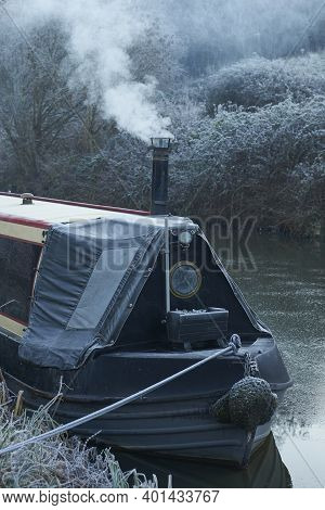 Bath, Somerset, United Kingdom - December 31, 2020: Smoke From The Chimney Of A Narrowboat On A Fros