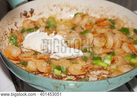 Spoonful Of Cream Cheese In A Frying Pan With Shrimp And Green Onion