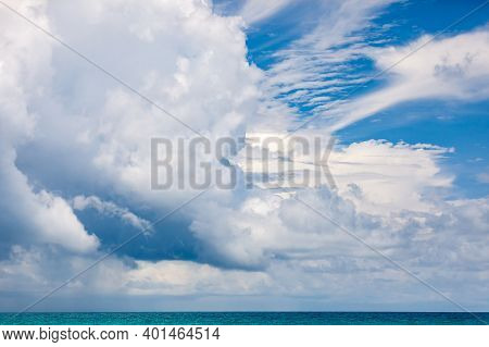 Seascape With A Distant Horizon, A Huge Cloud Hanging Low Over The Sea, In The Distance It Is Rainin