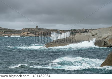 Stormy Mediterranean Sea Crashing Onto The Rocky Coastline At Punta Caldanu In The Balagne Region Of
