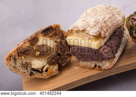 Korean Sweet Red Bean With Butter Bread And Fig Bread On A Wooden Board