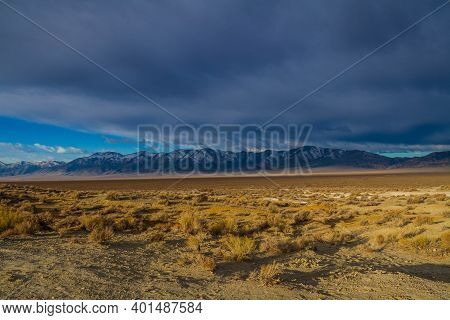 Snowcapped Mountains Across A Valley In Nevada Along Highway 376.