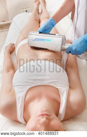 Vertical Shot Of A Woman Enjoying Full Body Slimming Treatment With Endospheres Device At Cosmetolog