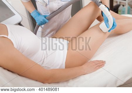 Cropped Shot Of A Beautician Removing Hair On The Bosy Of Female Client, Using Laser Hair Removal Ap