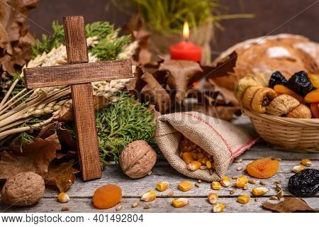 Traditional Food For Orthodox Christmas Eve. Yule Log Or Badnjak, Wooden Cross, Bread, Cereals Dried