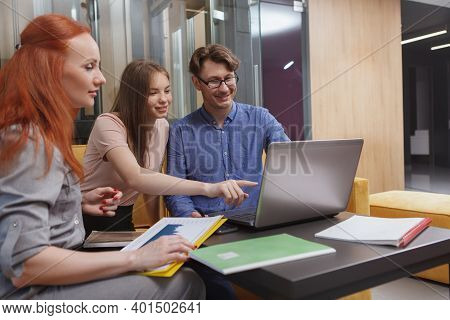 Group Of Creative Designers Using Laptop, Meeting At Open Space Office