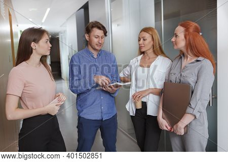 Group Of Entrepreneurs Talking In The Corridor At Their Workplace