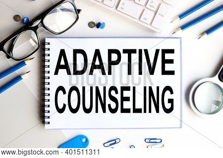 Adaptive Counseling, Text On White Paper On White Background Near The Keyboard