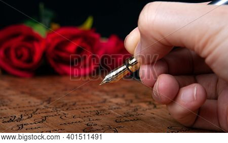 Fountain Pen In The Hand On Letter With Text And Red Rose Close Up