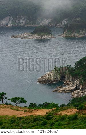 Rocks And Grotto On The Seashore, Foggy Day At Sea, Coastline Of Telyakovsky Bay Primorsky Krai, Rus