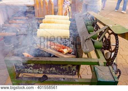 Traditional Hungarian Spit Cinnamon, Chimney Cake Is Rotate For Equal Baking Over Glowing Charcoal E