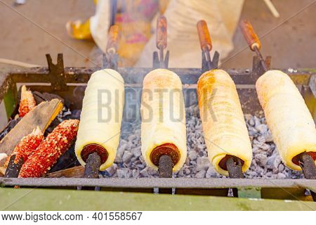 Traditional Hungarian Spit Cinnamon, Chimney Cake Is Rotate For Equal Baking Over Glowing Charcoal E