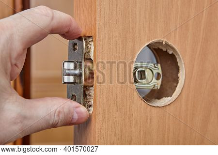Locksmith Shoves Latch Plate With Assembly Through The Edge Bore Of Interior Wood Door When Mounting