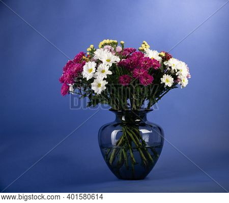 Clorfull Flowers Bouquet On Blue Background Studio Shot