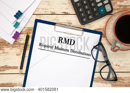Paper With Required Minimum Distributions Rmd On A Table, Calculator And Glasses