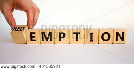 Redemption Or Emption Symbol. Male Hand Turns A Wooden Cube And Changes The Word 'emption' To 'redem