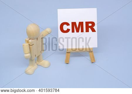 A Wooden Figure Of A Man Points To The Inscription Cmr. Business Concepts