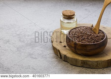 Linseed Oil Jar Wooden Bowl With Flax Seeds On Concrete Background, Dietary Cereal Ingredient That R