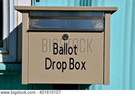 A Ballot Drop Box Is Fastened To A Door Allowing Voters To Leave Writing-in Voting Ballets.