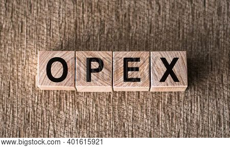 Abbreviation Opex (operational Expenditures) - Text On Wooden Cubes On A Brown Background. Business 