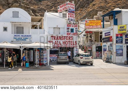 Santorini, Greece - September 19, 2020: Street With Shops In Athinios Ferry Port In Santorini. Cycla