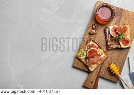 Delicious Sandwiches With Figs, Proscuitto And Cheese On Light Table, Top View. Space For Text