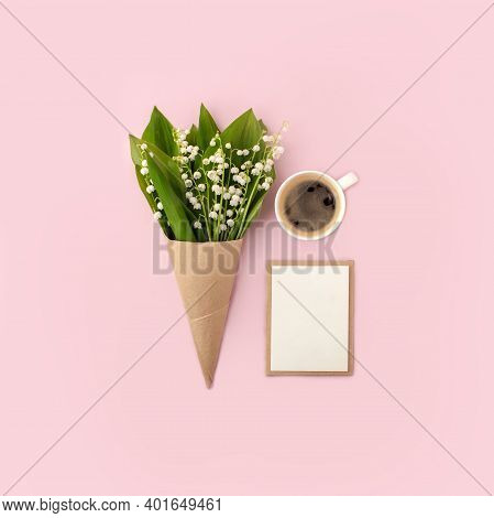 Floral Springtime Composition With Lily Of The Valley, Craftpaper Envelope, Cup Of Coffee, White Bla