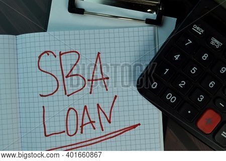 Sba Loan Write On A Book Isolated On Wooden Table. Business Or Finance Concept